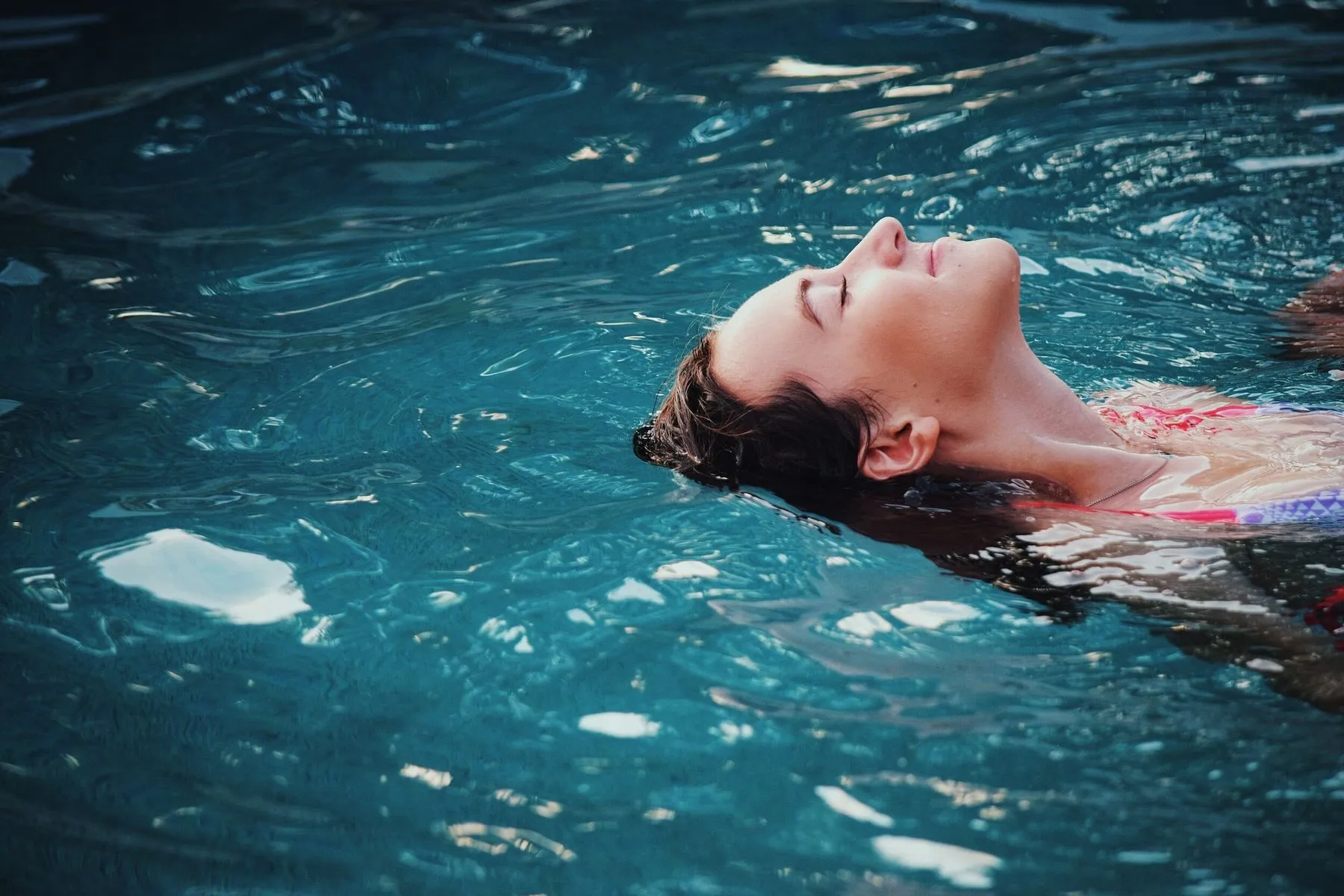 A person floating in a warm hydrotherapy pool