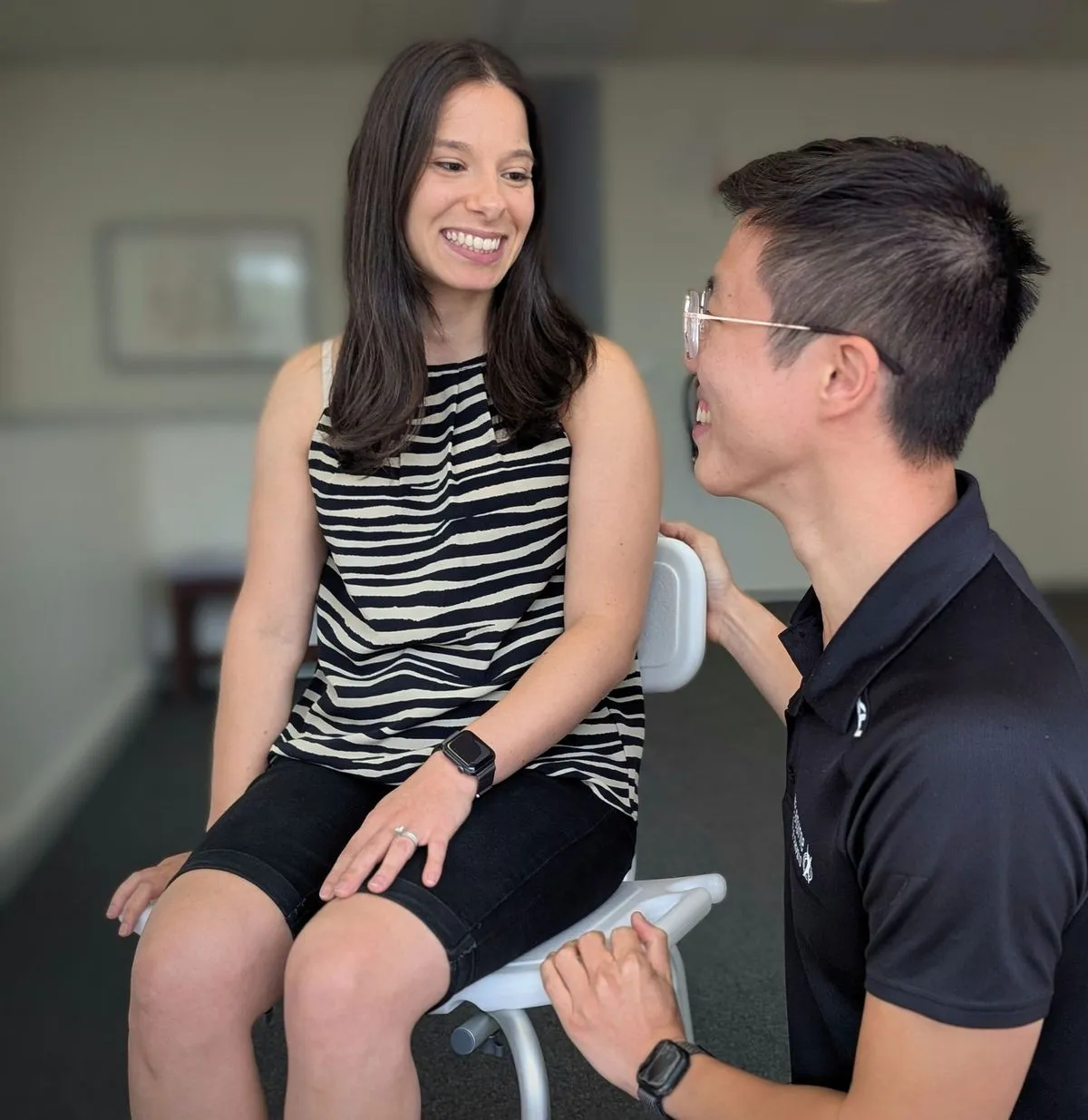 A physiotherapist assessing a client at home