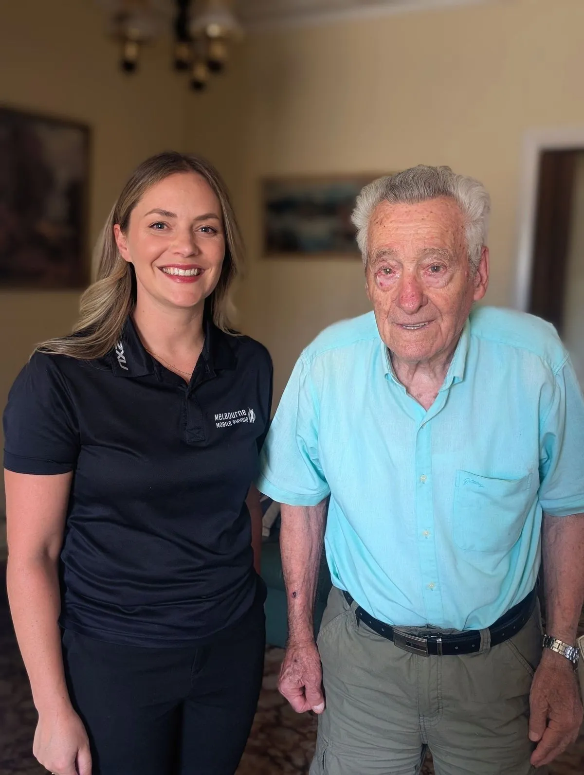 A physiotherapist with an older client at home